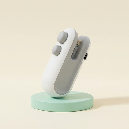 The Seal'd Mini pocket bag sealer with twin buttons — exactly what ships, on a mint pedestal